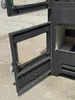 A close-up view of an open wood-burning stove door, showing the interior and the door mechanism. Produktbild-Vorschau
