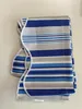 A folded striped awning valance on a white surface. Produktbild-Vorschau