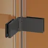 A close-up view of a black shower hinge on a glass partition. Produktbild-Vorschau