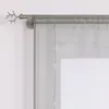 A close-up view of a curtain rod with a decorative antler-shaped finial and a sheer, light gray curtain hanging from it. Produktbild-Vorschau