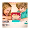 Two children are looking at a small aquarium with a red and teal base. Voir les images du produit