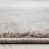 A close-up view of the edge and texture of a gray rug. Produktbild-Vorschau