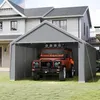 A grey tent garage is set up on a grassy lawn in front of a house, with an orange SUV parked inside. Náhled obrázku produktu