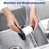 Hands washing a vacuum cleaner filter under a running faucet in a sink. Produktbild-Vorschau