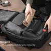 A person is packing a backpack with clothes and accessories. Produktbild-Vorschau