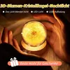 Hands holding a glowing crystal ball with a dandelion inside, on a wooden base, with a soft, furry background. Produktbild-Vorschau