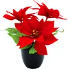 A close-up studio shot of a red artificial poinsettia plant in a black pot. Voir les images du produit