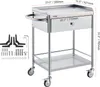 A stainless steel rolling cart with a drawer and two shelves, shown with dimensions and included accessories. Produktbild-Vorschau