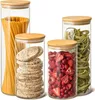 Four glass storage jars with bamboo lids, filled with different food items. Produktbild-Vorschau