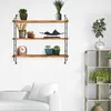 A three-tiered wooden shelf with various decorative items and plants. Produktbild-Vorschau