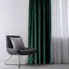 A dark green velvet curtain is shown next to a modern gray chair with a gray patterned pillow. Produktbild-Vorschau