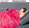 A woman sleeping under a pink blanket on a sofa. Produktbild-Vorschau