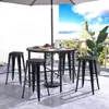 A round outdoor table with four black bar stools, set up on a patio with a view of a city skyline and blue sky. Náhľad obrázku produktu