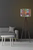 A modern living room with a gray sofa, a white coffee table, and a colorful patterned floor lamp. Produktbild-Vorschau