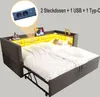 A dark gray upholstered bed with a built-in shelf and LED lighting, shown in an open state with the pull-out bed extended. A close-up inset highlights the electrical outlets and USB ports. Náhled obrázku produktu