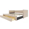A beige upholstered daybed with two drawers pulled out, showing the slatted bed frame. Podgląd zdjęcia produktu