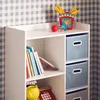 A white shelving unit with blue and gray storage boxes and books. Produktbild-Vorschau