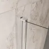 Close-up of a shower door hinge and glass panel against a tiled wall. Produktbild-Vorschau