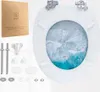 A toilet seat with a printed ocean wave design, along with its packaging and installation hardware, laid out on a white background. Produktbild-Vorschau