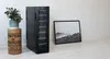 A wine cooler is placed on a white surface next to a framed picture and a decorative plant. Produktbild-Vorschau