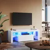 A modern living room with a TV stand and a large TV mounted on the wall. The TV stand has LED lighting. Náhled obrázku produktu