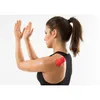Woman using a massage ball on her shoulder. Produktbild-Vorschau