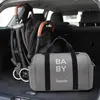 A baby stroller and a diaper bag are placed in the trunk of a car. Náhľad obrázku produktu