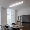 A modern office setting with a desk, chairs, and a ceiling light. Náhled obrázku produktu