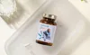 A bottle of probiotic capsules is placed on a white tray, with a glass of water and some loose capsules nearby. The bottle has a label with an illustration of a person. Produktbild-Vorschau