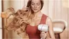 A woman is drying her hair with a Philips hair dryer. Náhled obrázku produktu