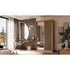A bedroom scene featuring a wardrobe, dressing table, and bed, with a large window overlooking a natural landscape. Produktbild-Vorschau