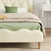 A close-up view of a bed with bedding and pillows. Náhled obrázku produktu