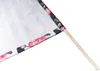 A close-up of a fabric flag with a floral print on a wooden stick. Produktbild-Vorschau