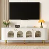 A white TV stand with gold accents and arched glass doors, with a TV mounted above it. Podgląd zdjęcia produktu