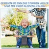 A child is happily swinging in a baby swing outdoors, with a person holding the swing ropes in the background. Produktbild-Vorschau