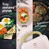 A collage showing three different food preparations: grilled sandwiches, waffles with strawberries, and grilled steaks, all potentially made with a sandwich maker. The bottom of the image shows the handle of a white sandwich maker with a wooden accent. Podgląd zdjęcia produktu