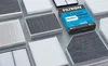 Several car air filters are displayed on a metallic surface, with one filter box in the foreground. Podgląd zdjęcia produktu