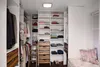 A well-organized walk-in closet with shelves, drawers, and hanging clothes. Produktbild-Vorschau