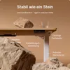 A desk with rocks and a glass of water, highlighting its stability. Produktbild-Vorschau