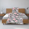 A floral patterned duvet cover and pillowcase set on a bed. Produktbild-Vorschau