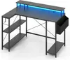 A black L-shaped desk with blue LED lighting on a white background. Produktbild-Vorschau