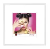 A framed picture of a woman with macarons, presented as a product image. Produktbild-Vorschau