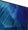 A close-up view of the edge of a television screen displaying a blue abstract image. Produktbild-Vorschau