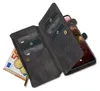 A black leather wallet case for a smartphone, open to reveal card slots, a zipper pocket with euro banknotes and coins, and a smartphone inside. Produktbild-Vorschau