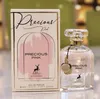A perfume bottle and its box are displayed on a reflective surface with a blurred green background. Produktbild-Vorschau