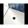 A black square drain is centered on a white tiled floor, with blue tiled walls in the background. Produktbild-Vorschau