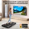 A woman is using a treadmill in a modern living room, with a large TV displaying a virtual running course. Náhled obrázku produktu