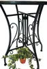 The base of a black metal garden table with a potted ivy plant hanging from it. Produktbild-Vorschau