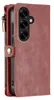 A close-up view of a pink wallet-style phone case with a zipper and a snap closure, showing the camera cutout on the back of a phone. Produktbild-Vorschau