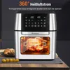 A silver and black air fryer with a chicken cooking inside, placed on a countertop with some food items nearby. Produktbild-Vorschau